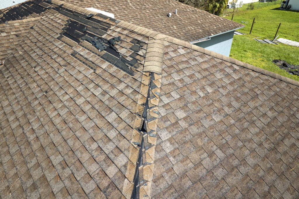 Damaged residential roof with missing shingles requiring professional repair in Nashville, TN.