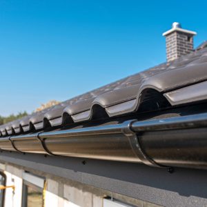 a-metal-black-gutter-on-a-roof-covered-with-ceram-2026-03-24-09-02-20-utc