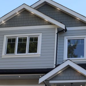A low-angle view of modern houses in the background of sky