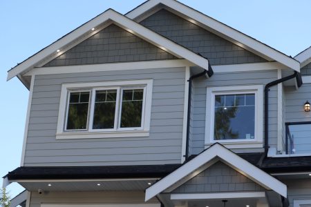 A low-angle view of modern houses in the background of sky