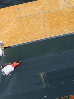 New asphalt bitumen shingles being installed on roof of residential building